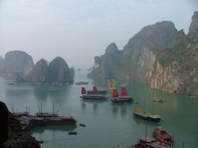 boats in a bay with limestone cliffs