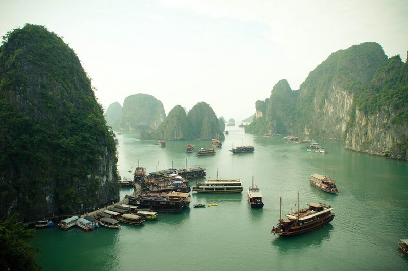 boats in a bay with limestone cliffs