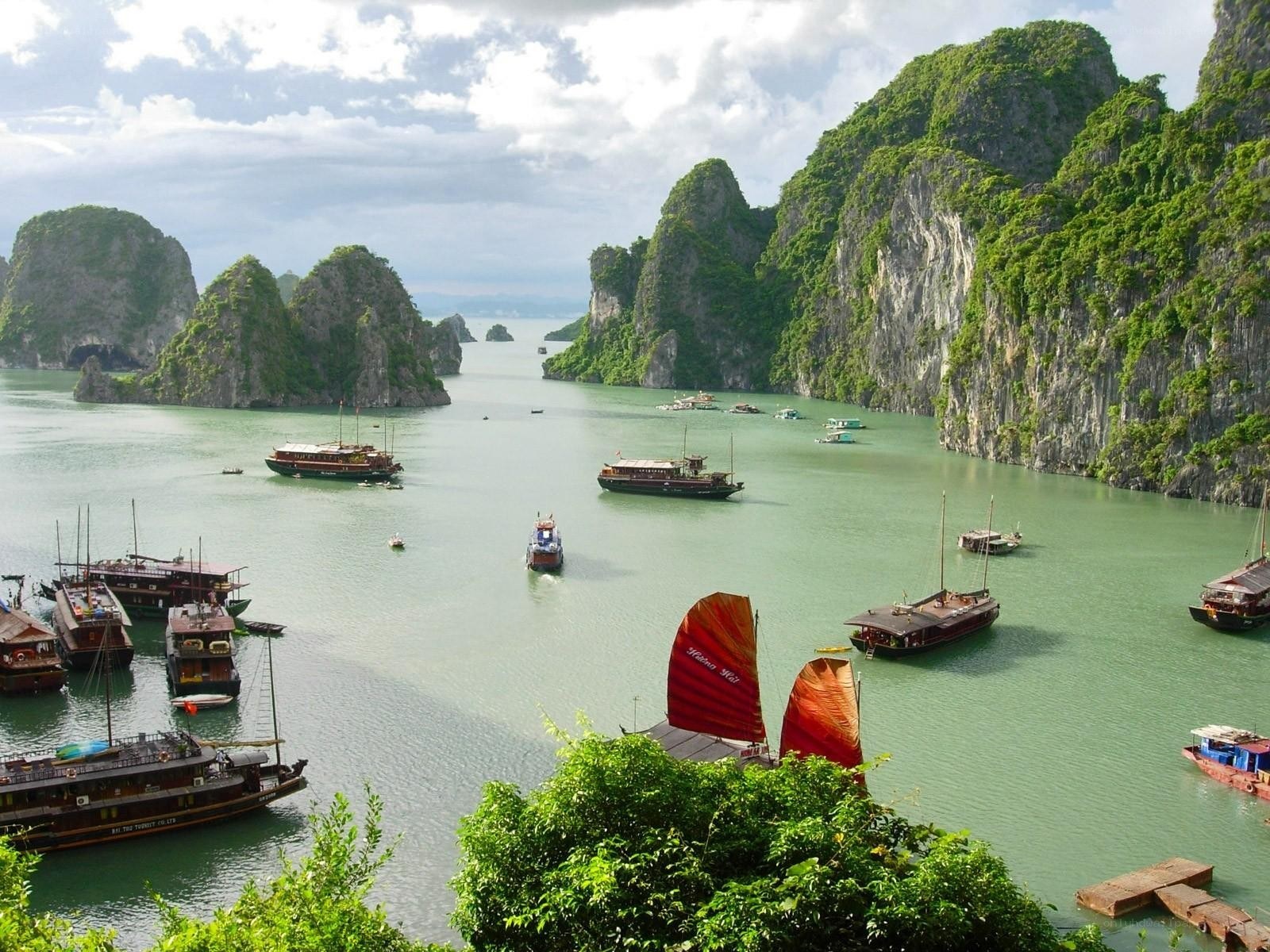 boats in a bay with limestone cliffs