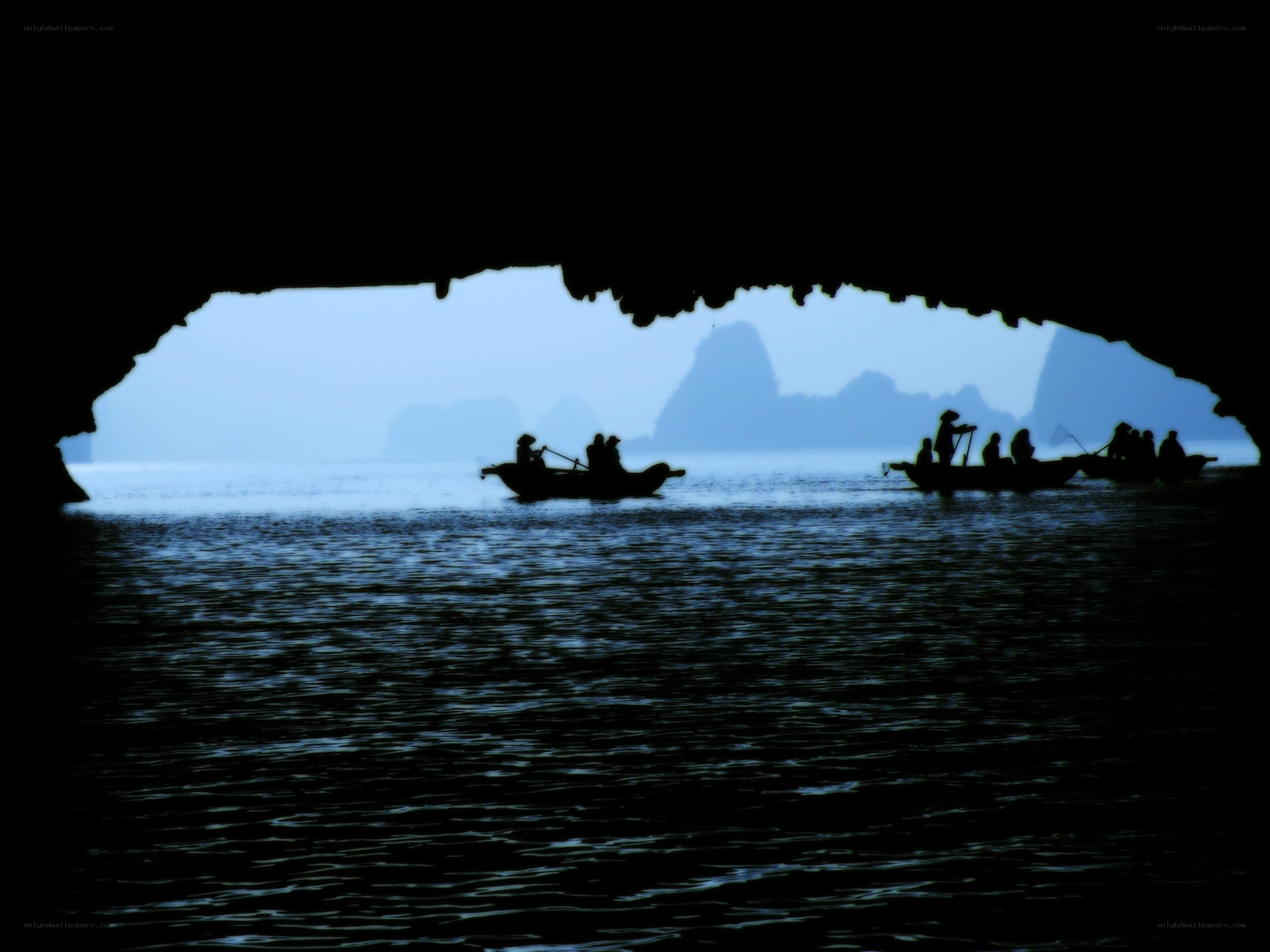 Boats in a cave opening