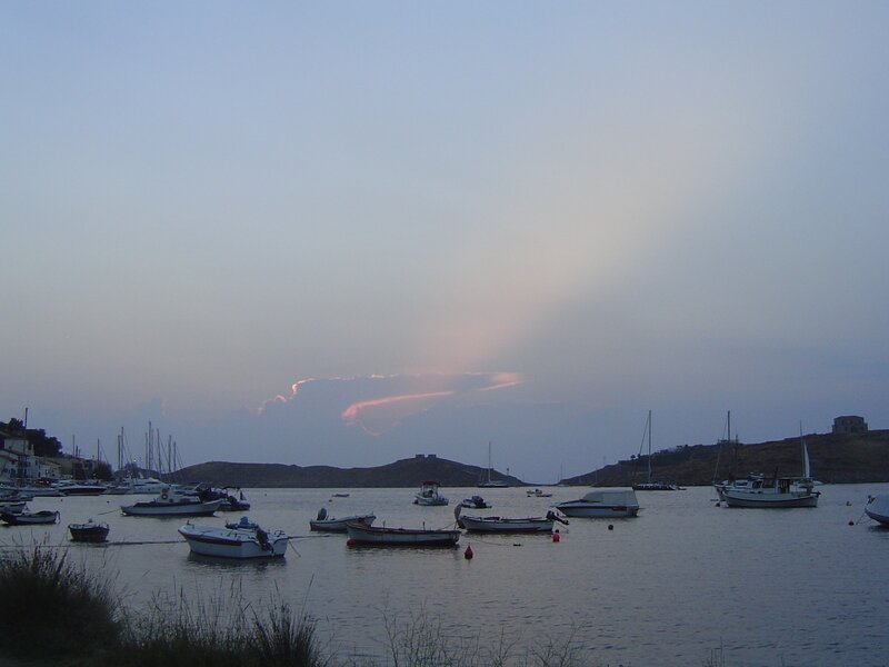 Boats in a harbor at dusk