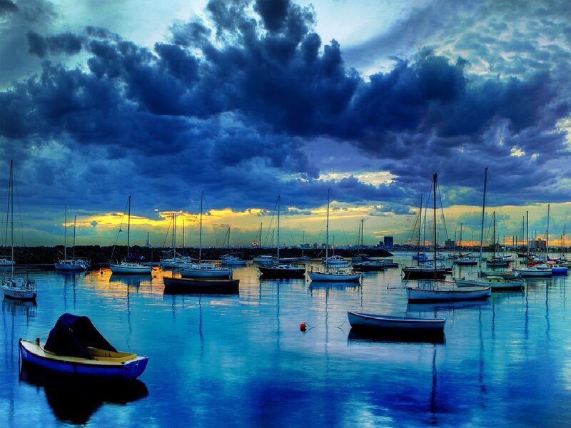 Boats in a harbor at sunset