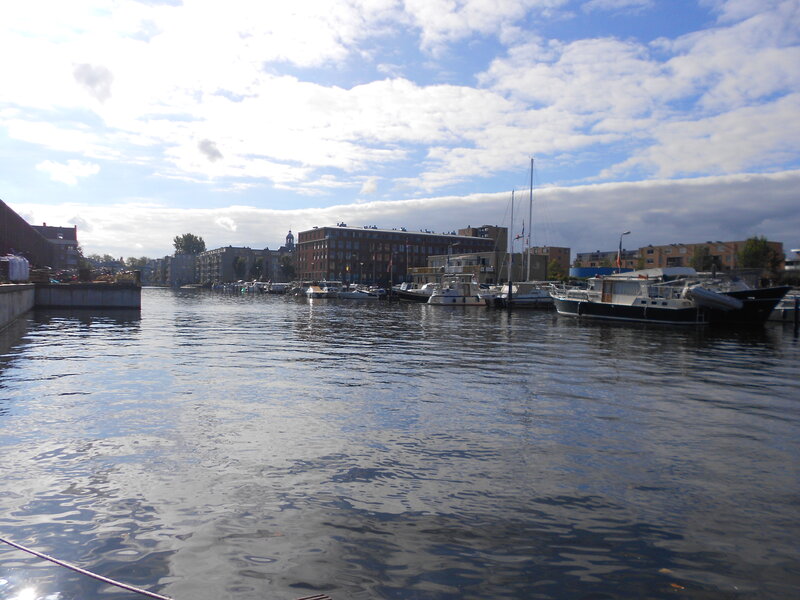 Boats in a Harbor — Blue, Calm, Afternoon, Photograph, Buildings, Sky