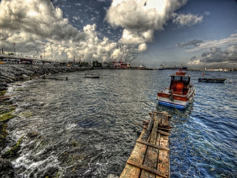 Boats in a harbor under cloudy sky