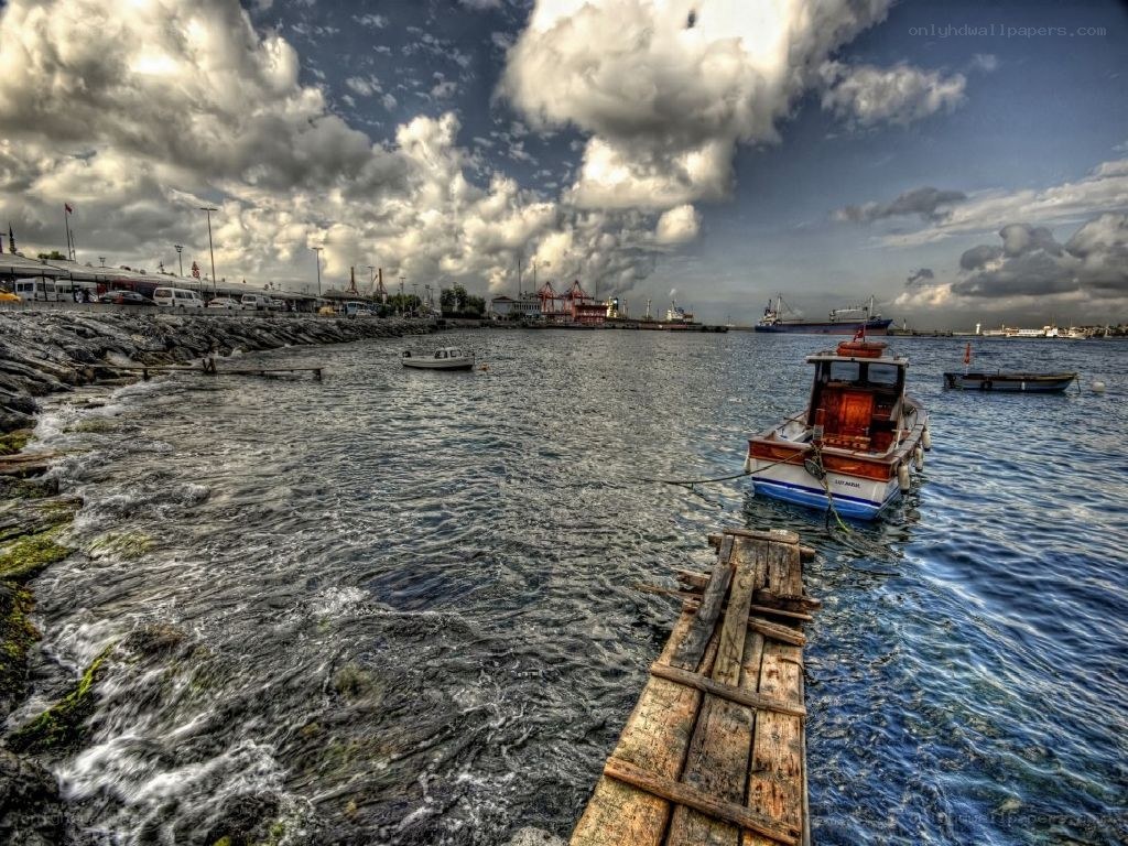 Boats in a harbor under cloudy sky