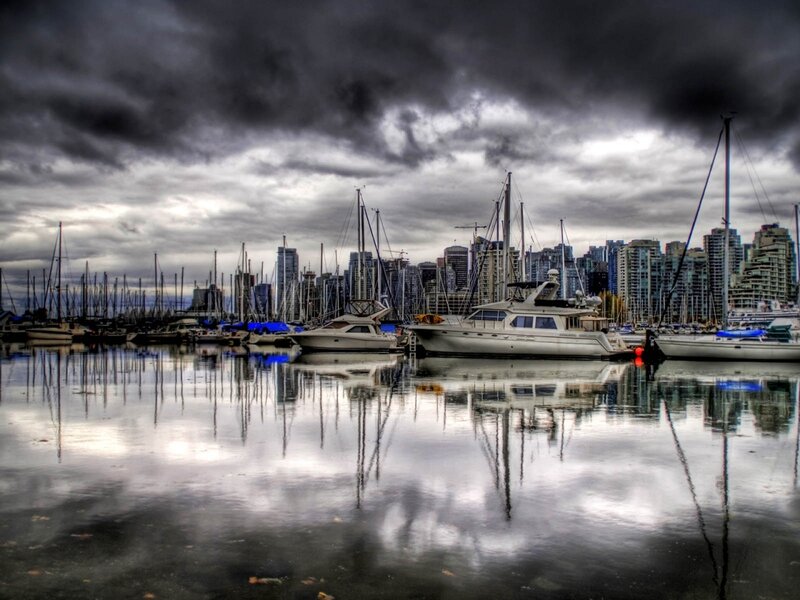 Boats in a harbor under stormy sky