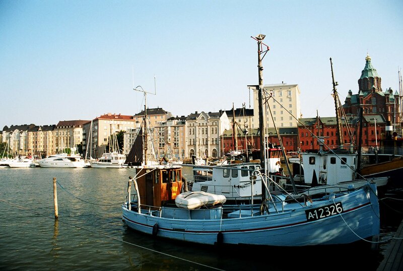Boats in a harbor with city buildings