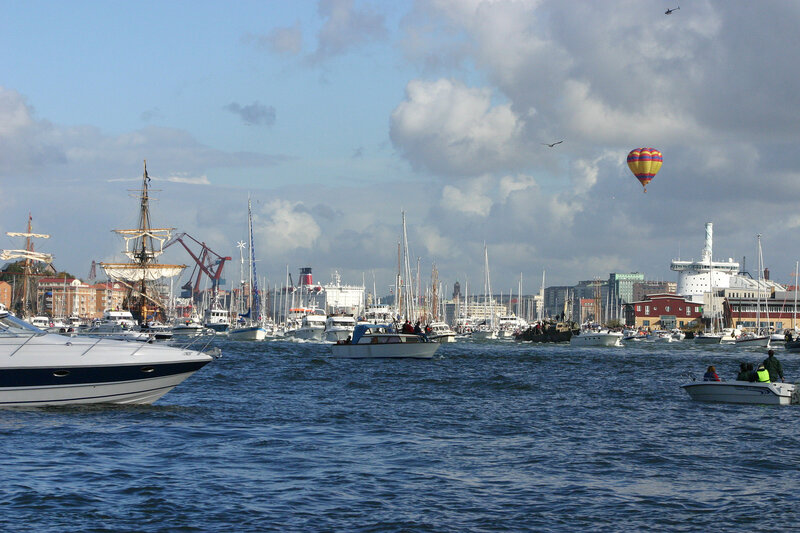 Boats in a harbor with hot air balloon