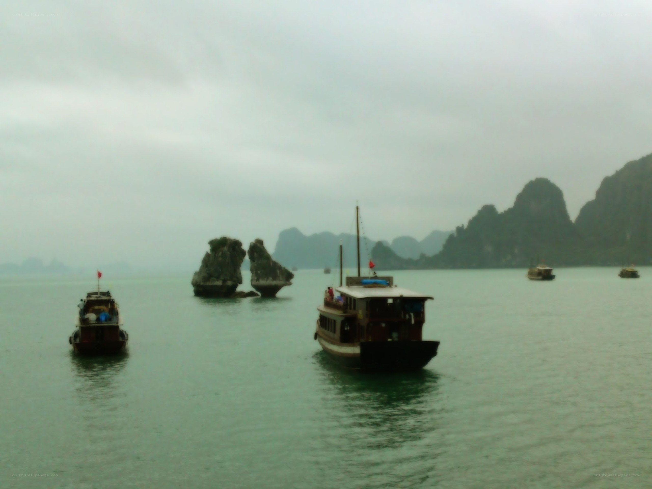 Boats in a misty bay