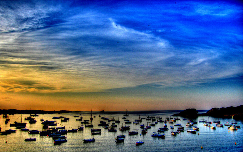 Boats in harbor at sunset