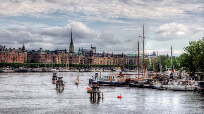Boats in Harbor with City