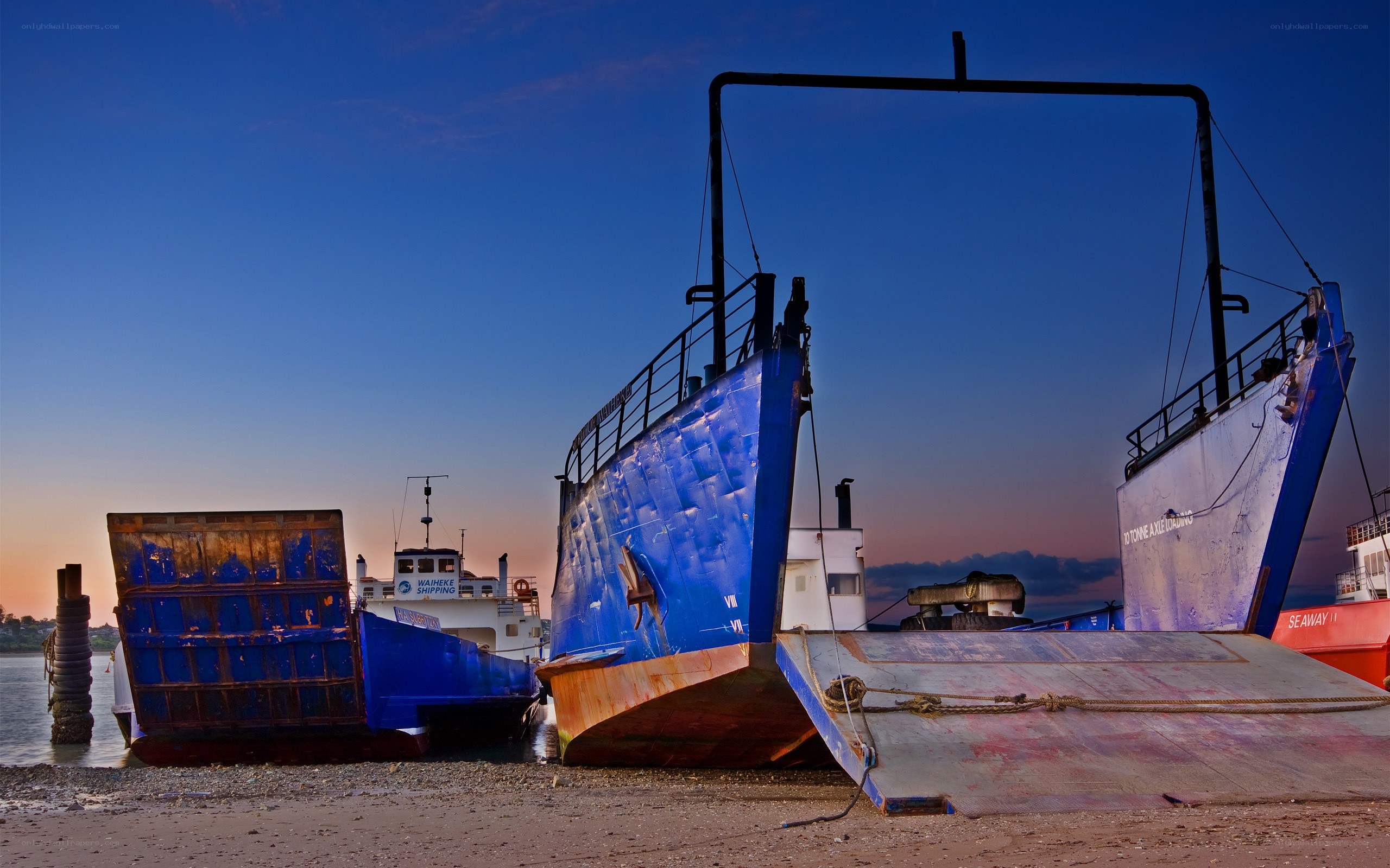 Boats on a beach at dusk