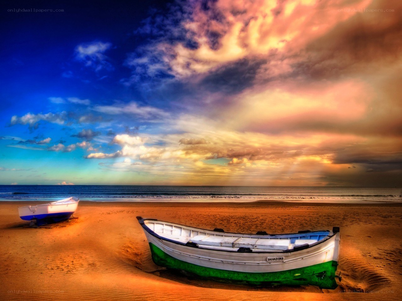 Boats on a beach at sunset