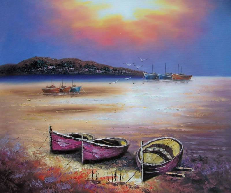 Boats on a beach at sunset