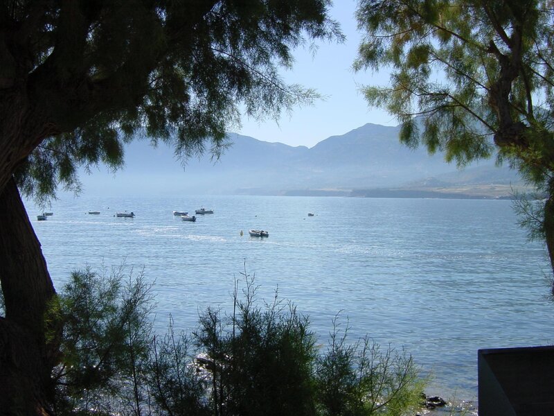 Boats on a calm bay with mountains