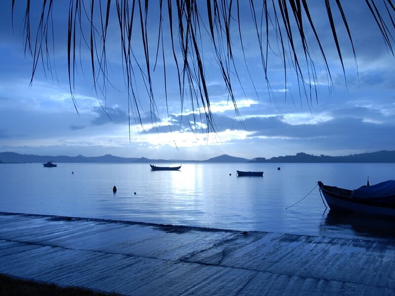 Boats on a calm lake at dusk