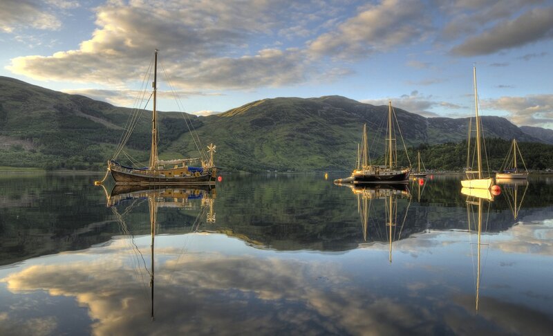 Boats on a calm lake at sunset