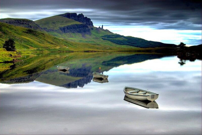 Boats on a calm lake with mountains