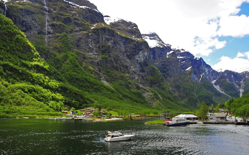 Boats on a fjord with mountains