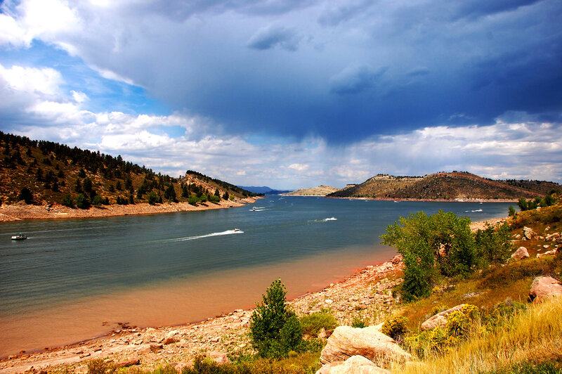 Boats on a lake under stormy sky