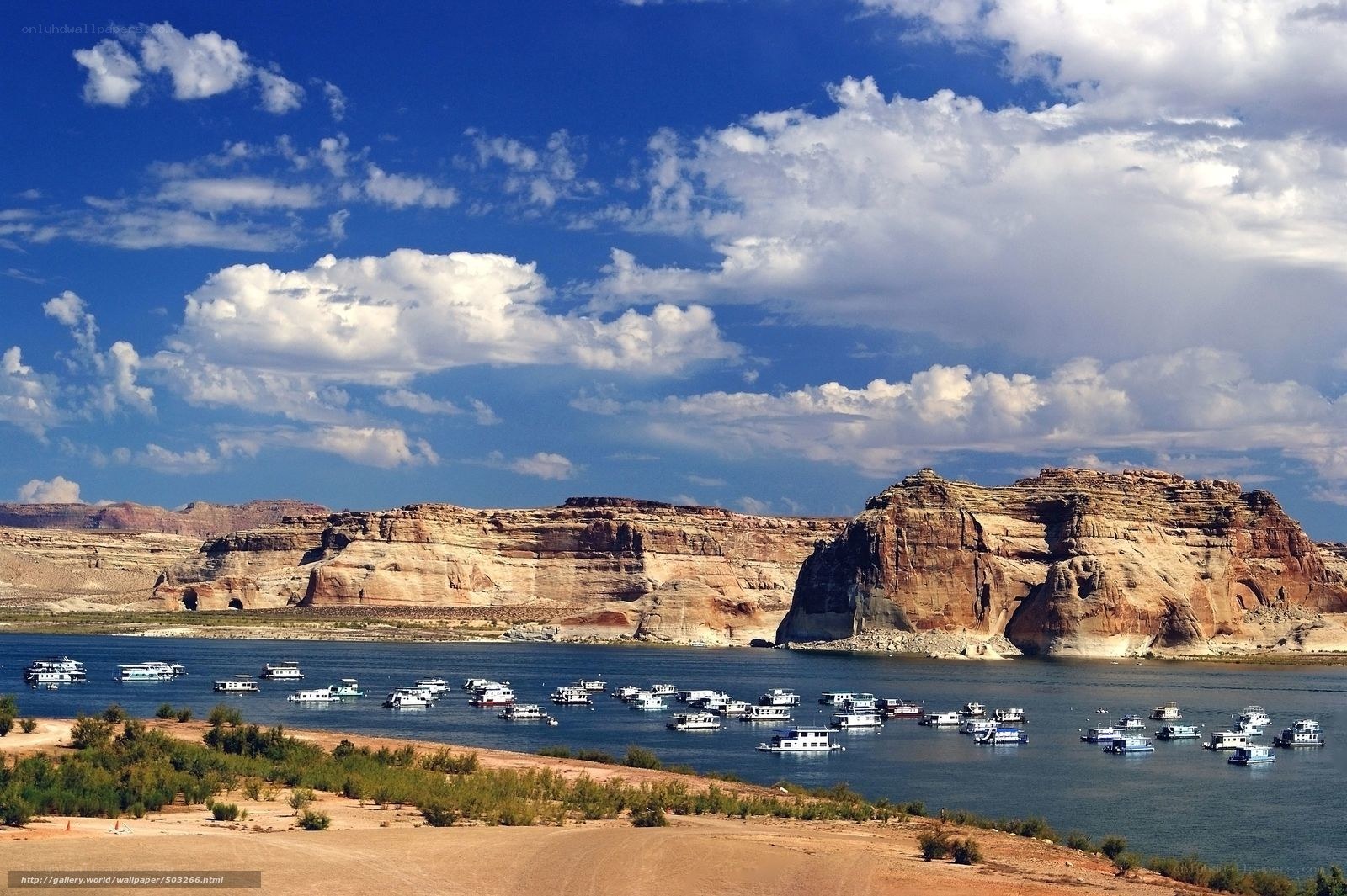 Boats on a lake with cliffs
