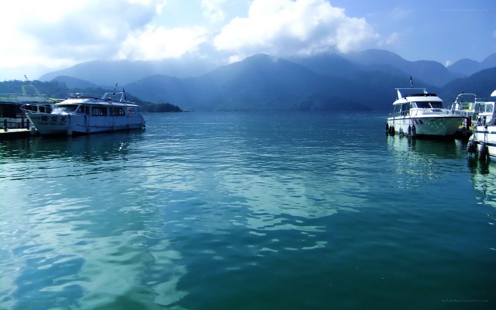 Boats on a lake with mountains