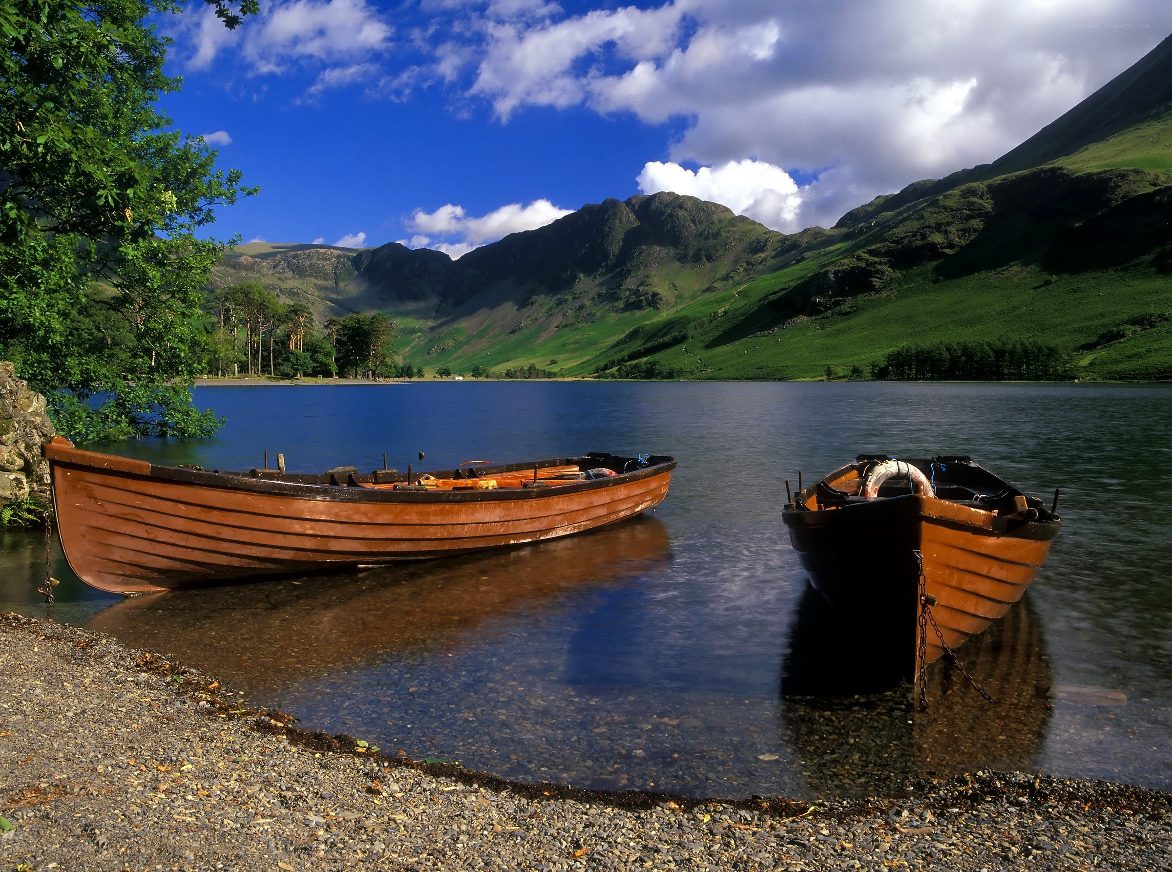 Boats on a lake with mountains