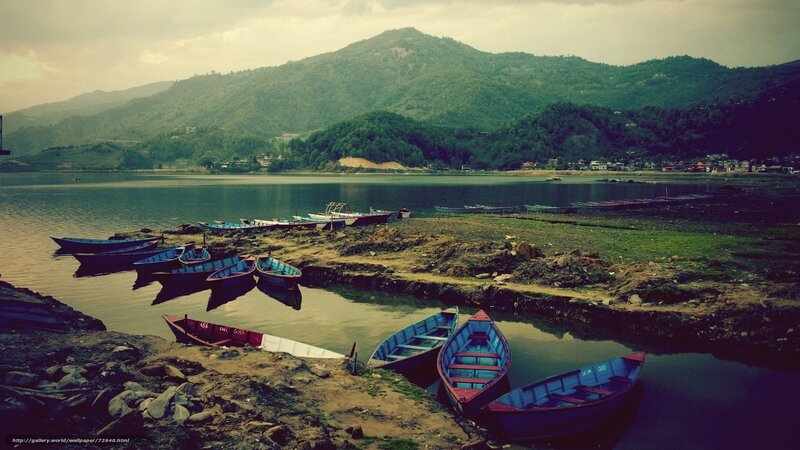 Boats on a lake with mountains