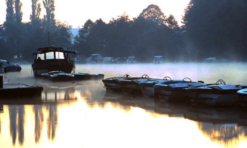 Boats on a misty lake at dawn