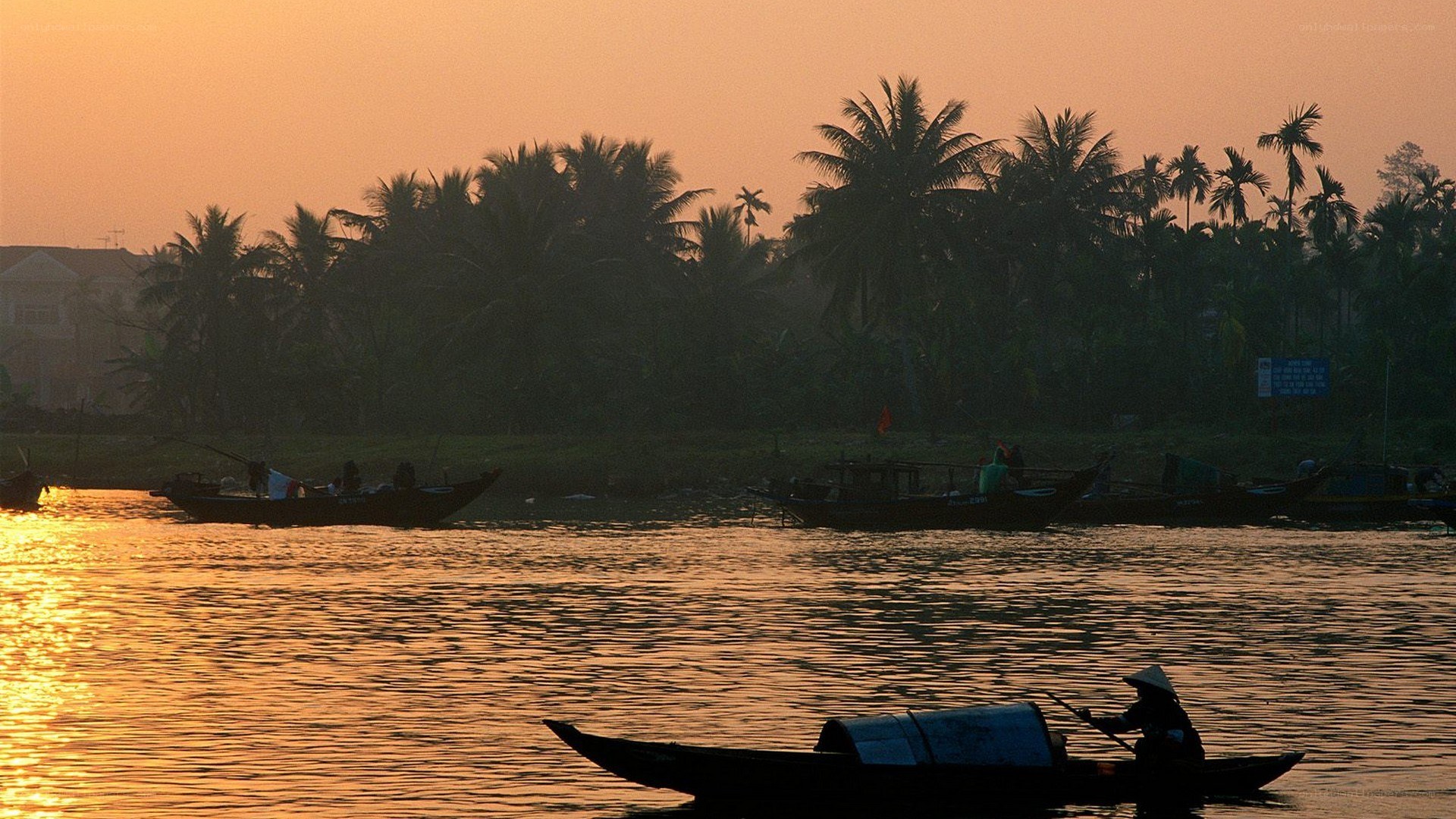 Boats on a river at sunset