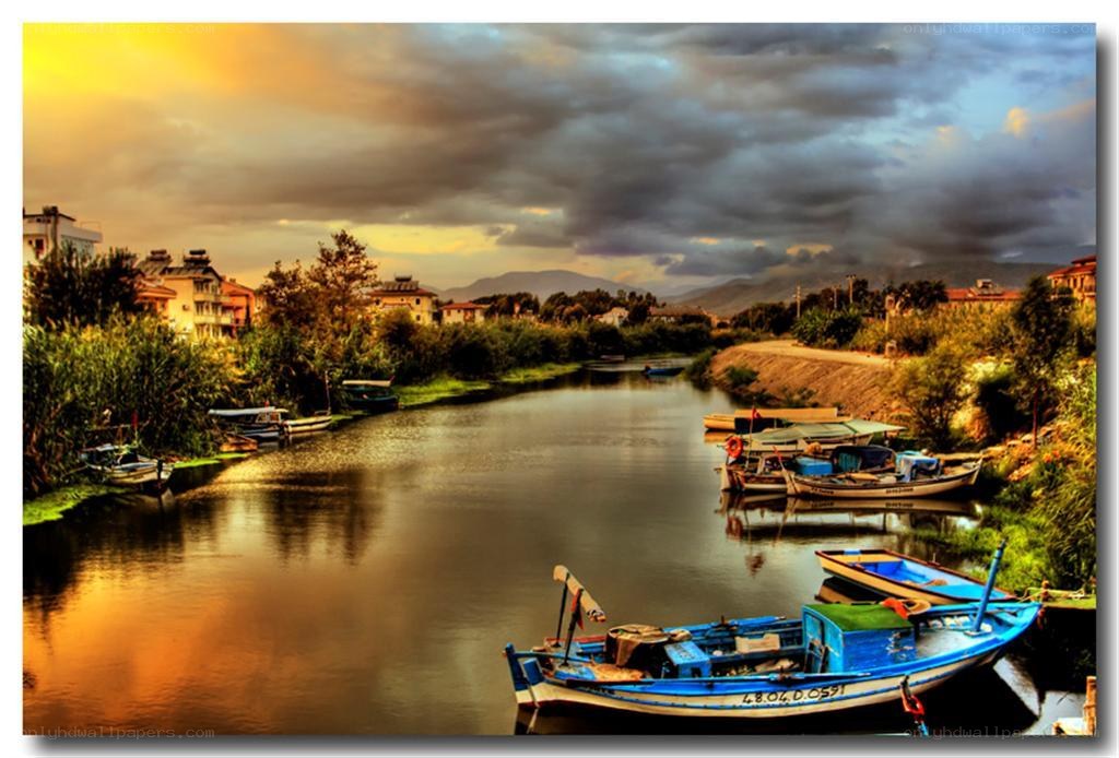 Boats on a river at sunset
