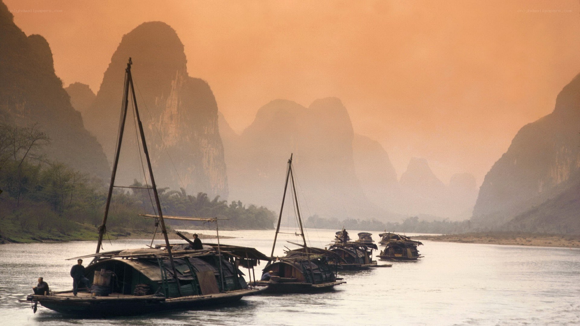 Boats on a river at sunset