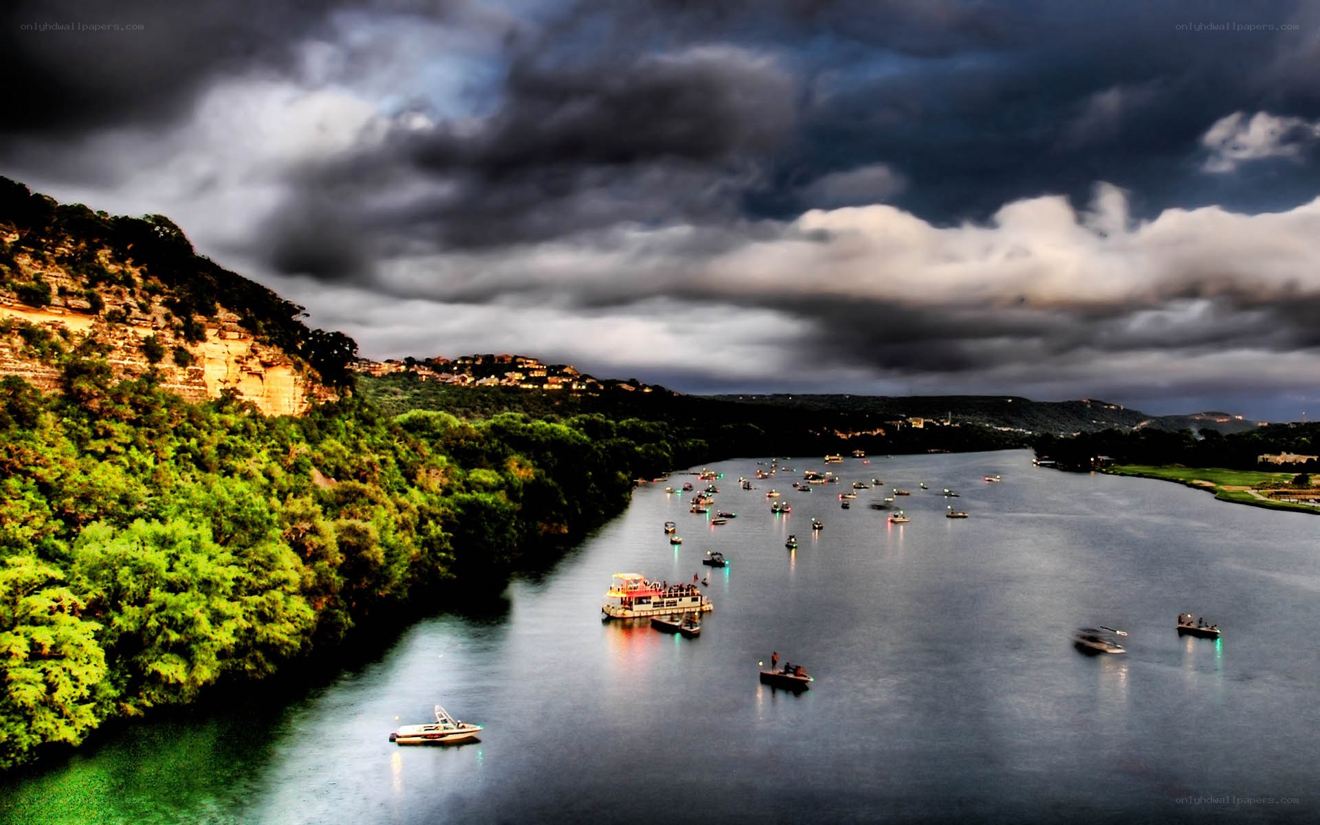 Boats on a river under stormy sky