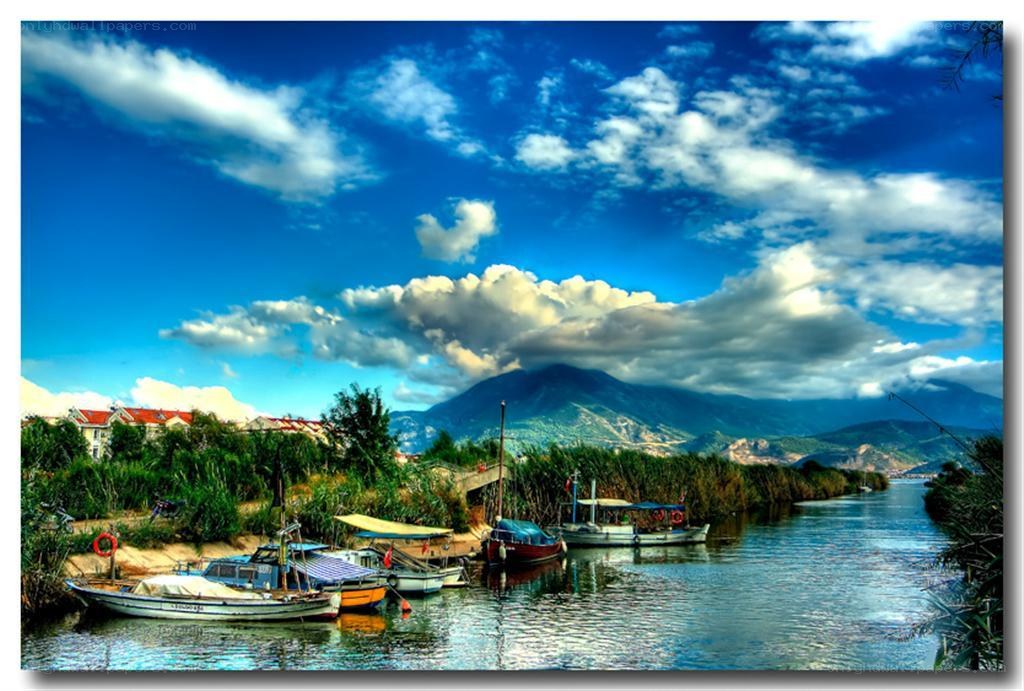 Boats on a river with mountains