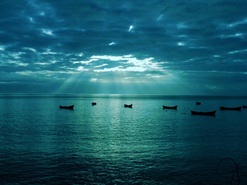 Boats on calm sea at dawn