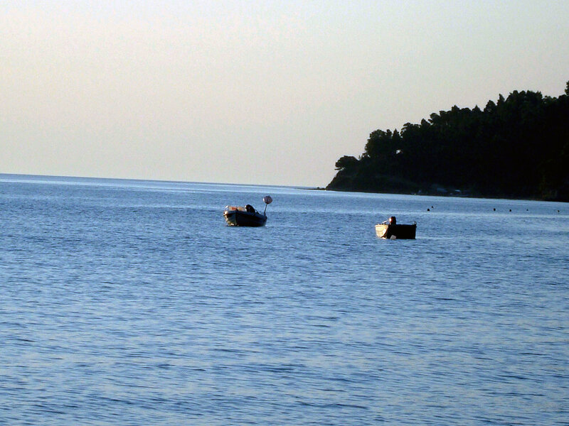 Boats on calm sea at dusk