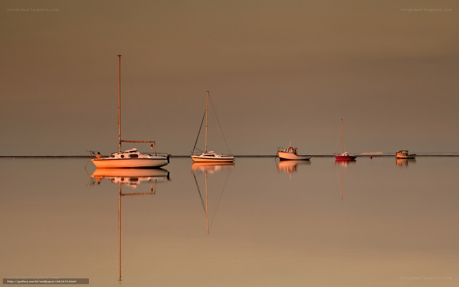 Boats on calm water at sunset