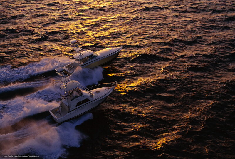 Boats on the ocean at sunset