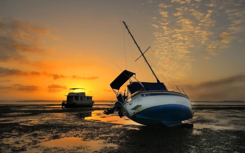 Boats on the shore at sunset