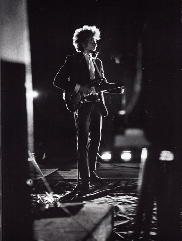 Bob Dylan on stage with guitar