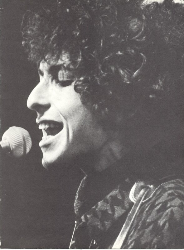 Bob Dylan singing into a microphone