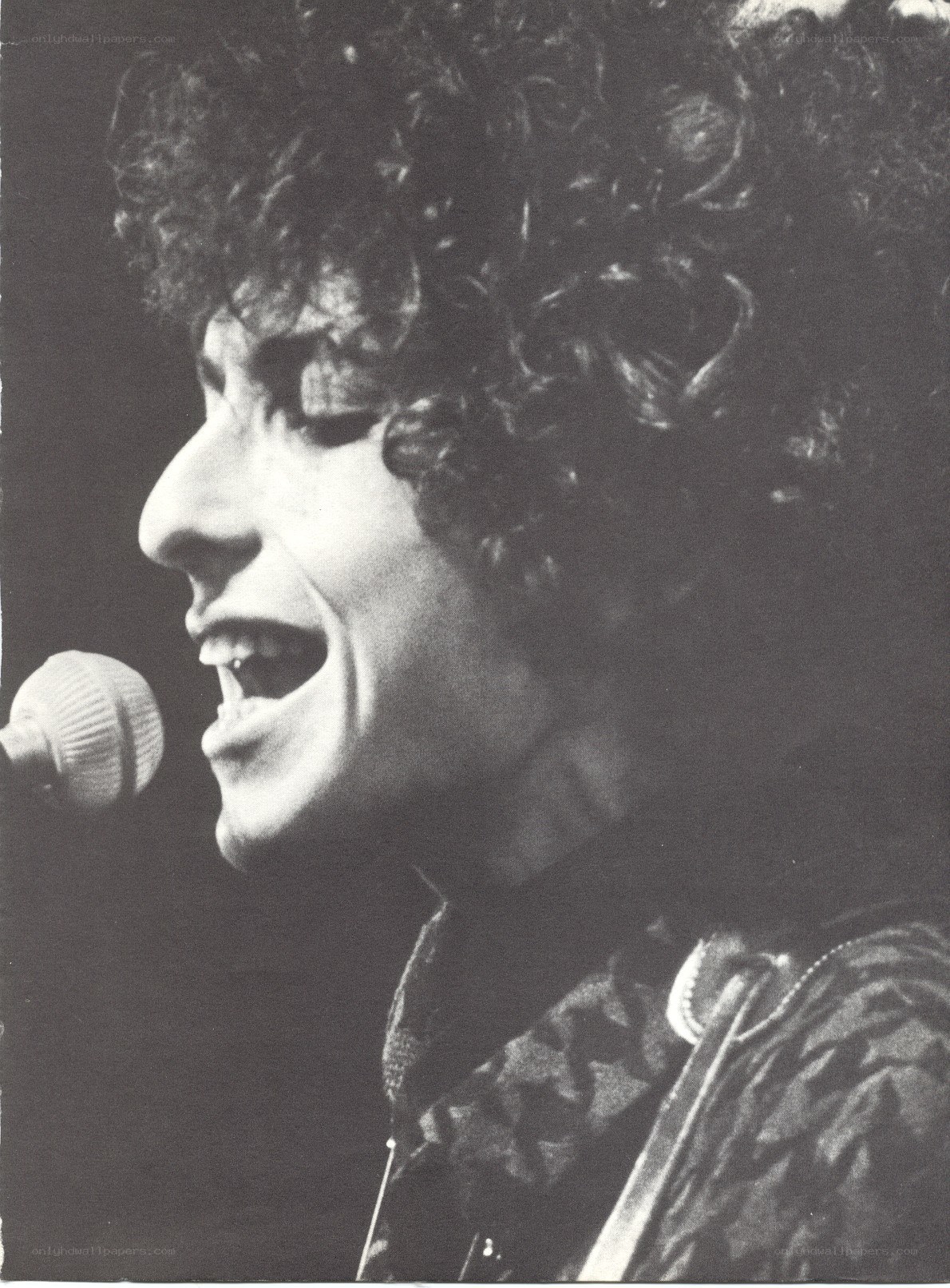 Bob Dylan singing into a microphone