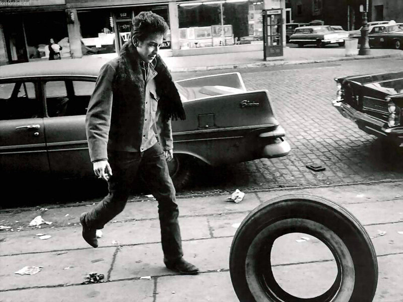 Bob Dylan walking on a city street