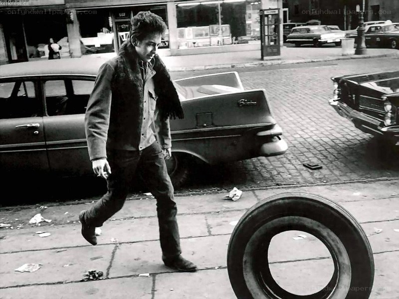 Bob Dylan walking on a city street