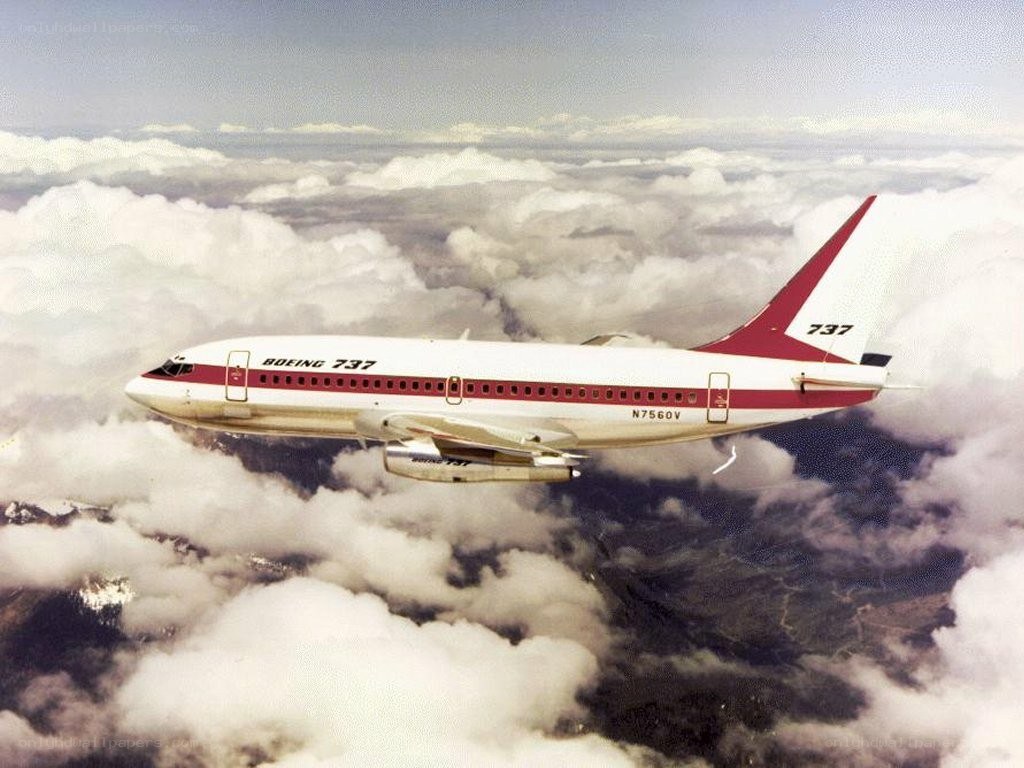 Boeing 737 flying above clouds