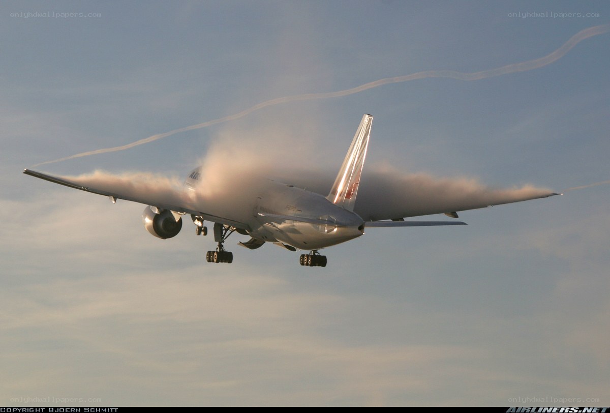 Boeing 747 in flight with condensation
