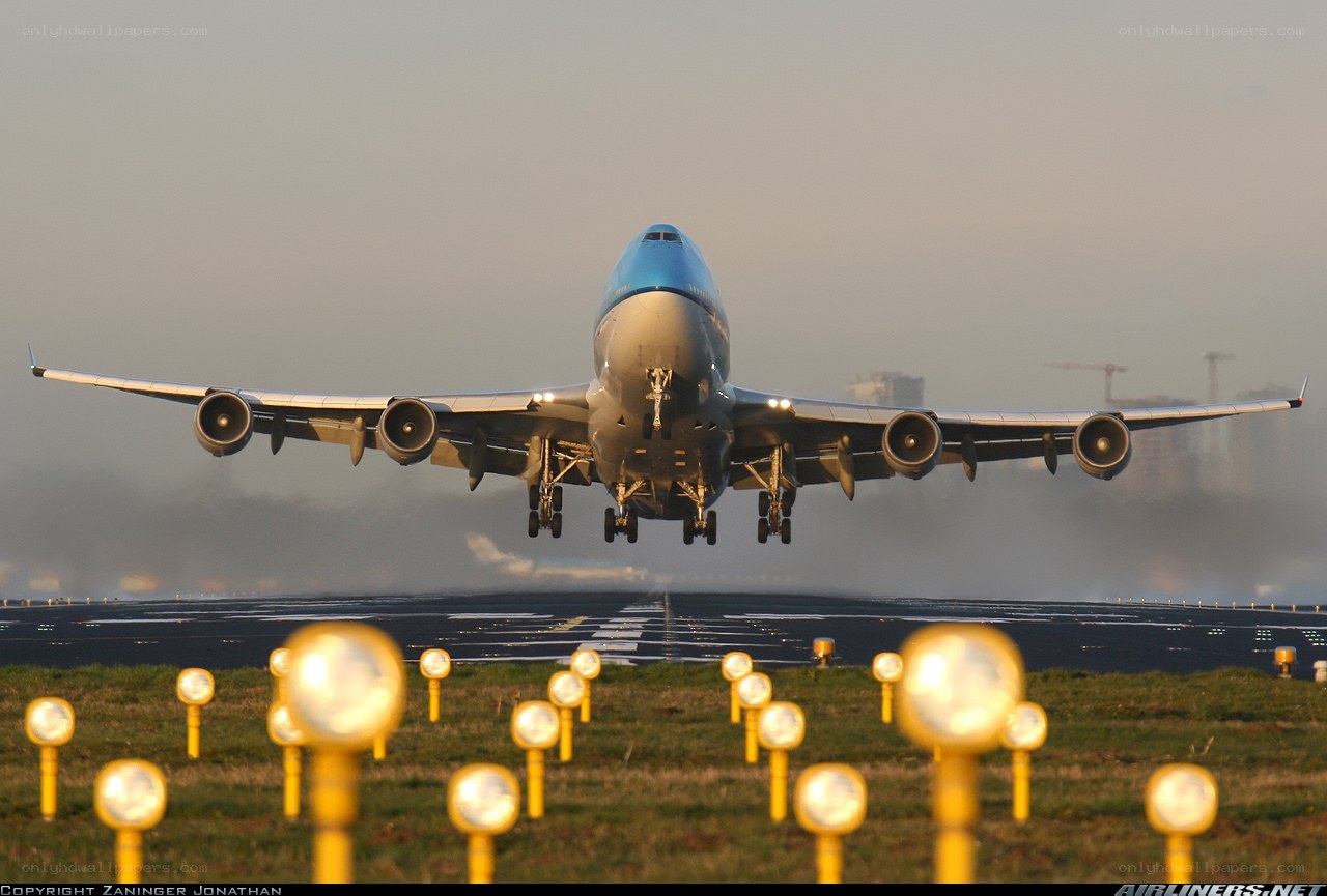 Boeing 747 landing at sunset