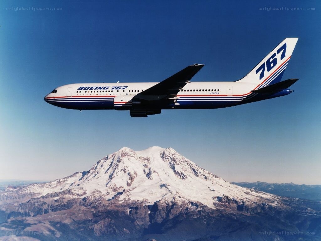 Boeing 767 over a snow-capped mountain