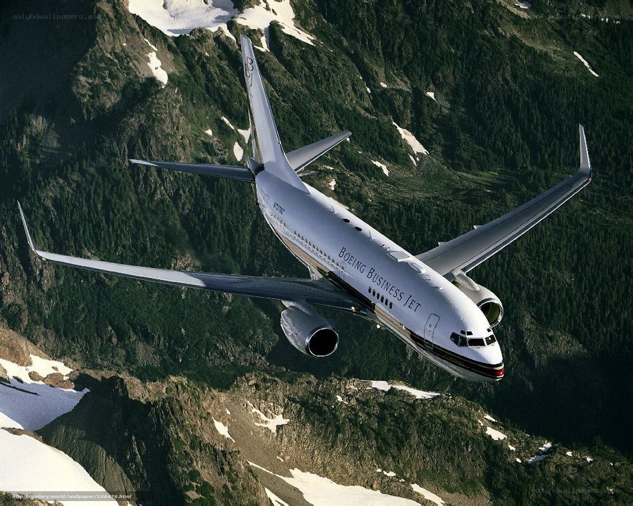 Boeing Business Jet over mountains