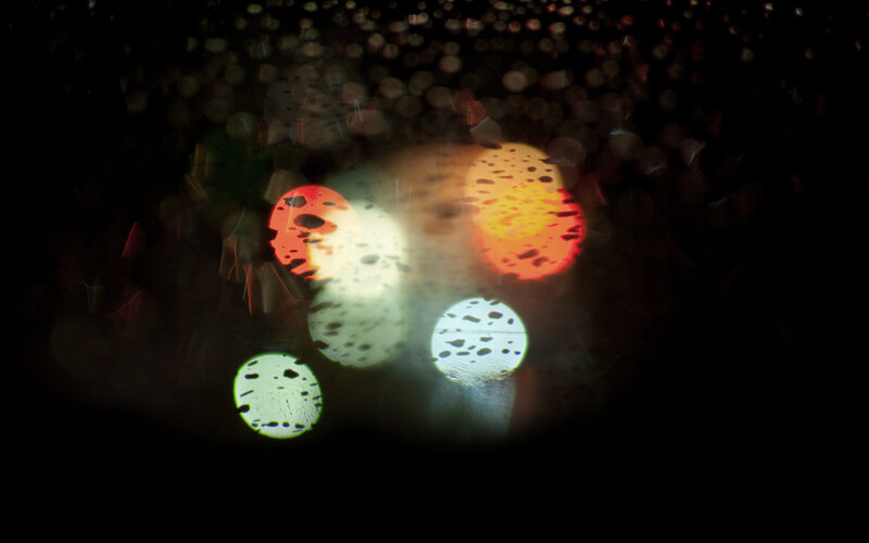 Bokeh lights through raindrops